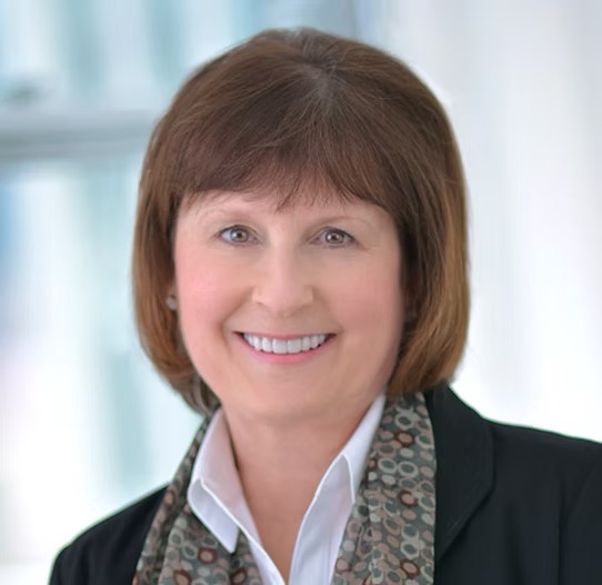 Headshot of Kendra J. Bjoraker, Ph.D.,L.P. Smiling in front of a neutral background.